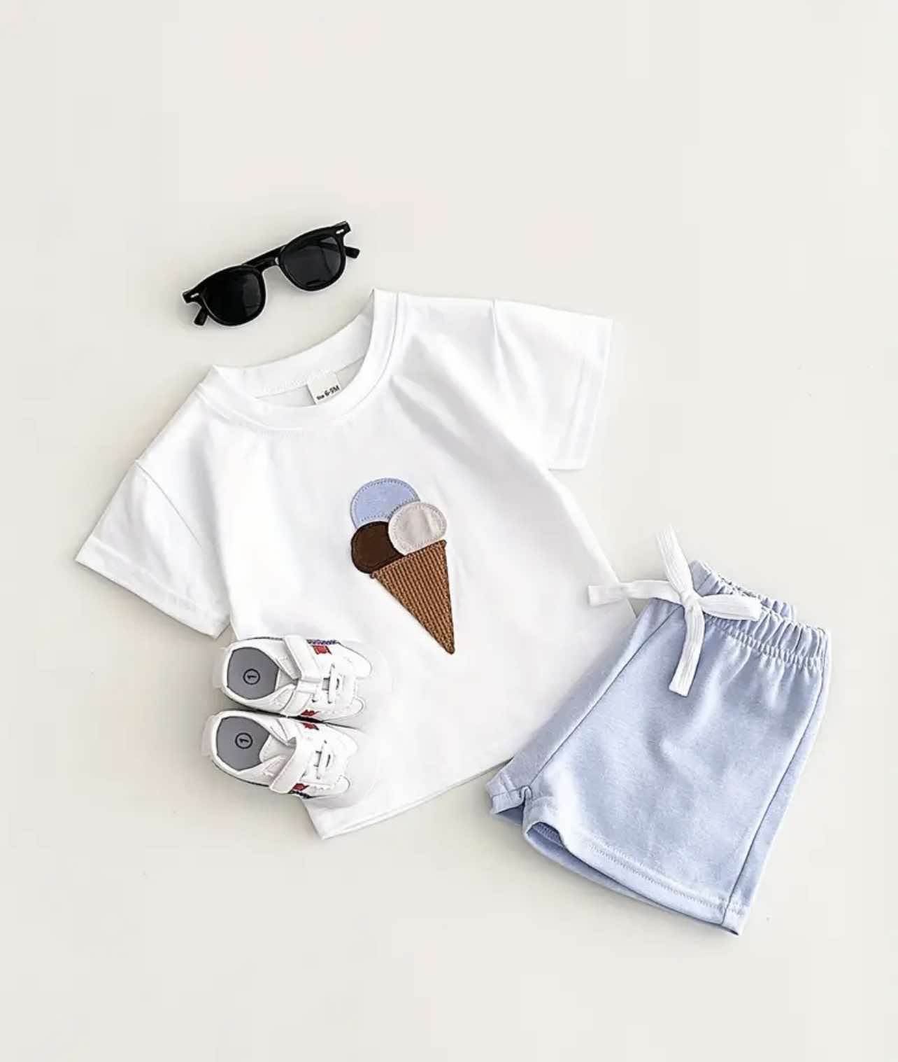 Adorable toddler summer outfit in Australia: white ice cream tee with light blue shorts.