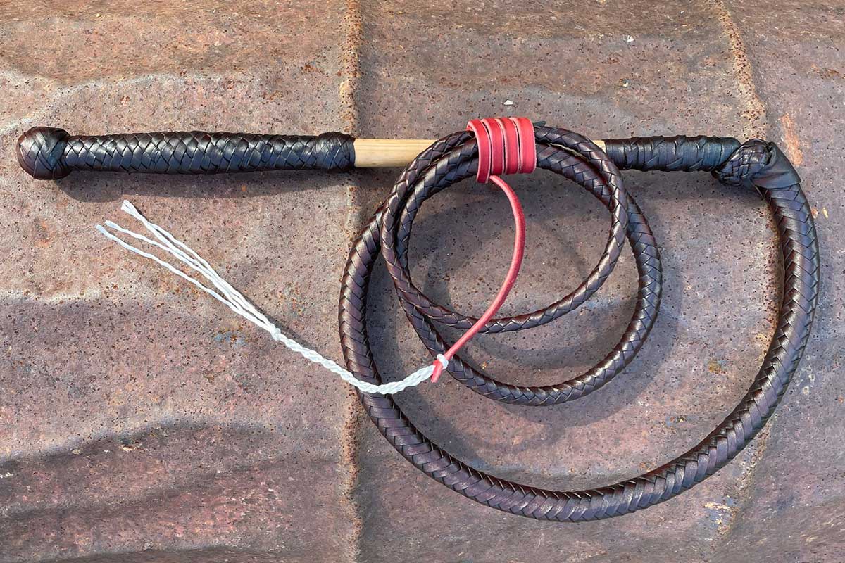 Adult Size 6 Foot Kangaroo Hide Stock Whip featuring a plaited kangaroo hide thong, cane handle, red hide tail, and bailing twine cracker. Perfect for big kids and adults, with 3 free crackers included.