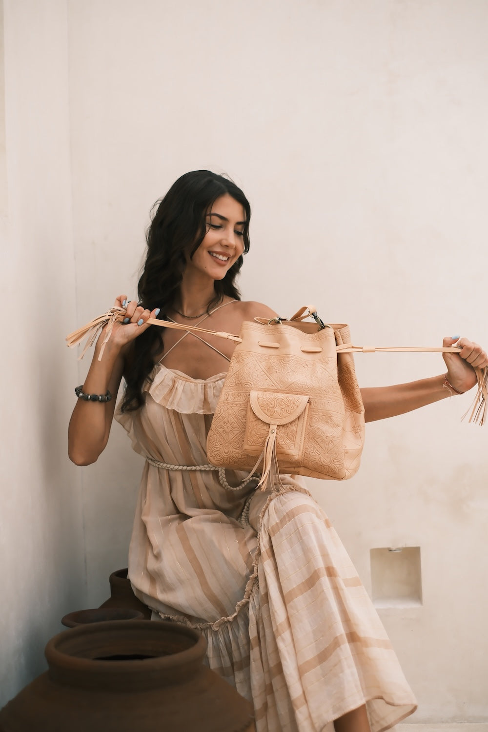 Artisan cowhide and goat leather crossbody with front pocket and fringe
