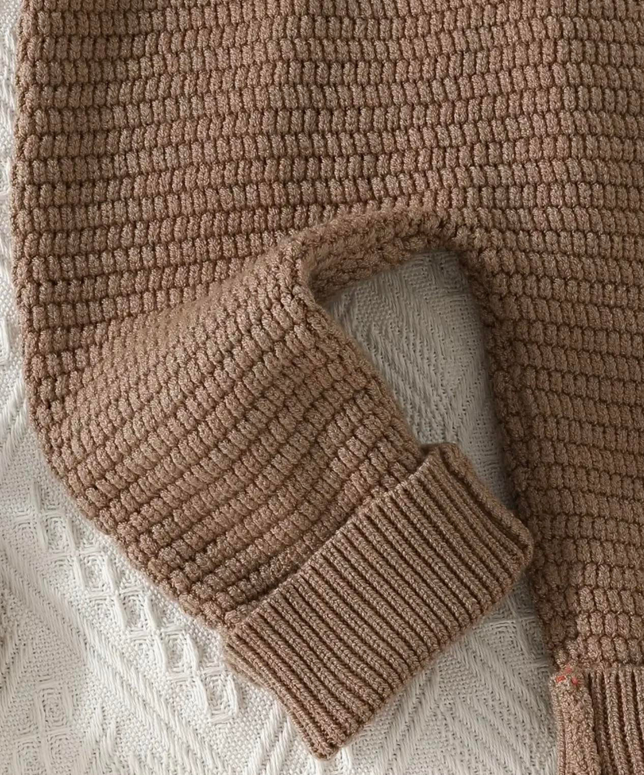 Baby in loose-fit casual knit jumpsuit with medium stretch fabric