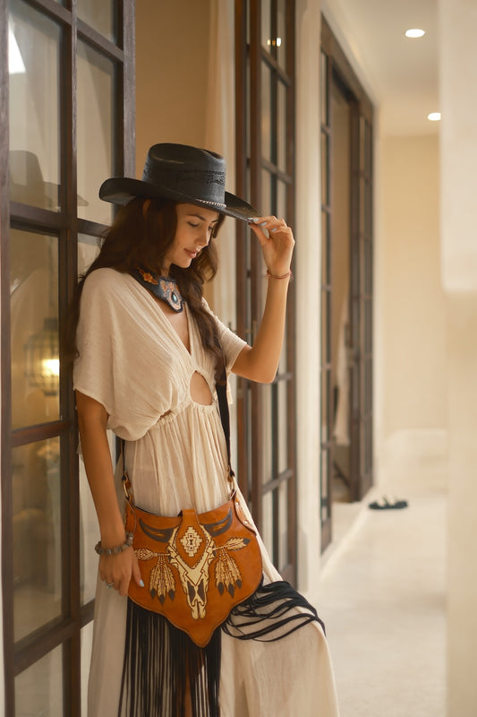 Black leather boho fringe bag with hand-tooled detailing, ideal for festivals, nights out, or everyday adventures.