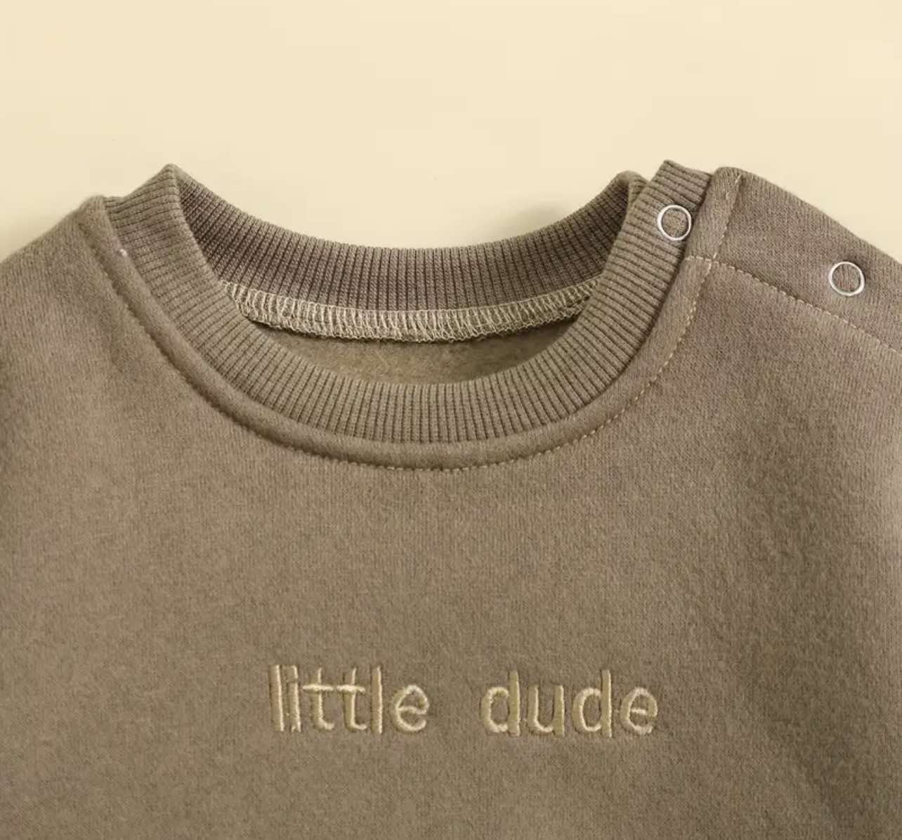 Close-up of vintage-inspired embroidery on blue ‘Little Dude’ bubble romper