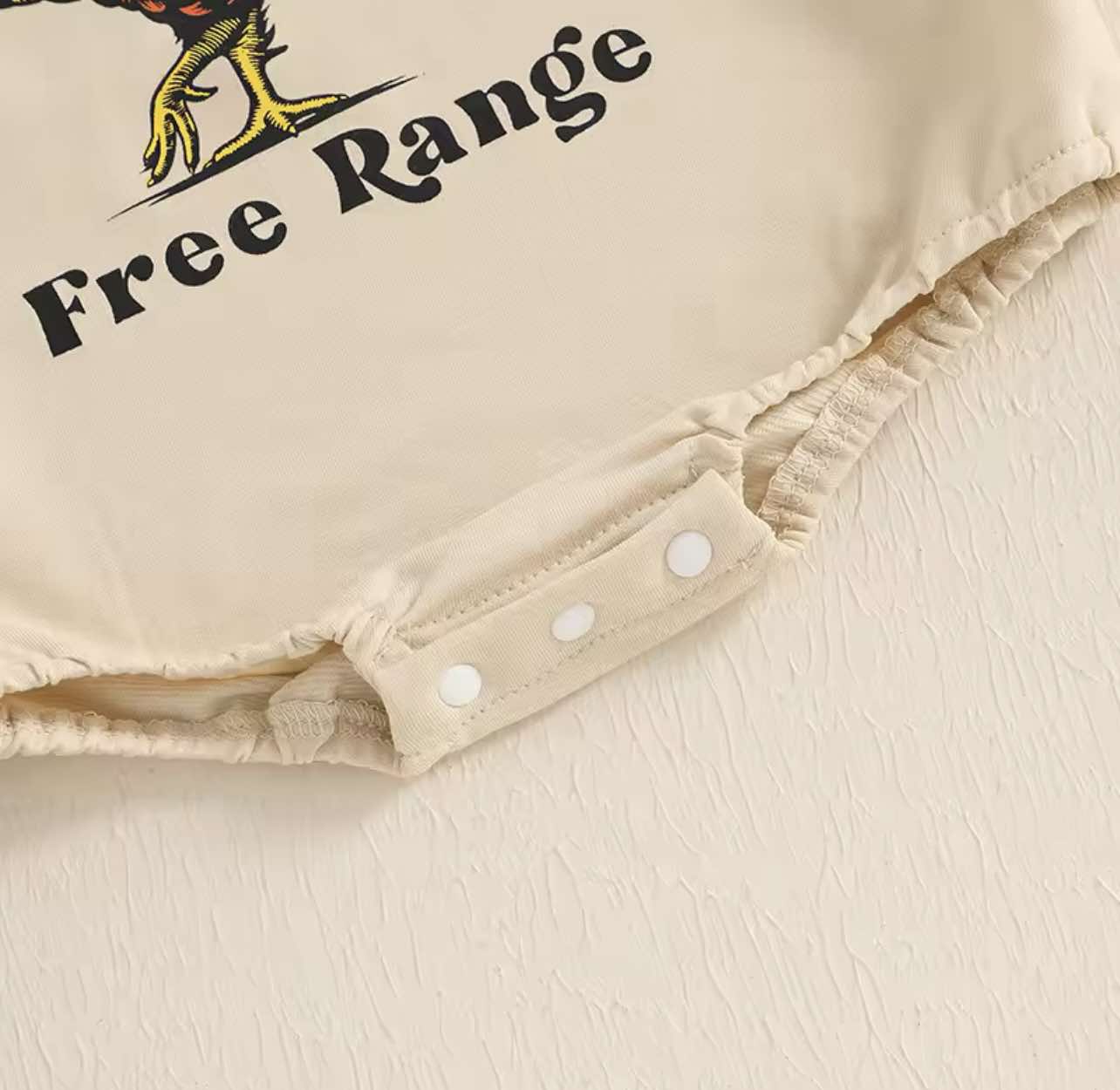 Country-style baby romper with 'Free Range' rooster design – breathable cotton blend, perfect for outdoor play and farm adventures.