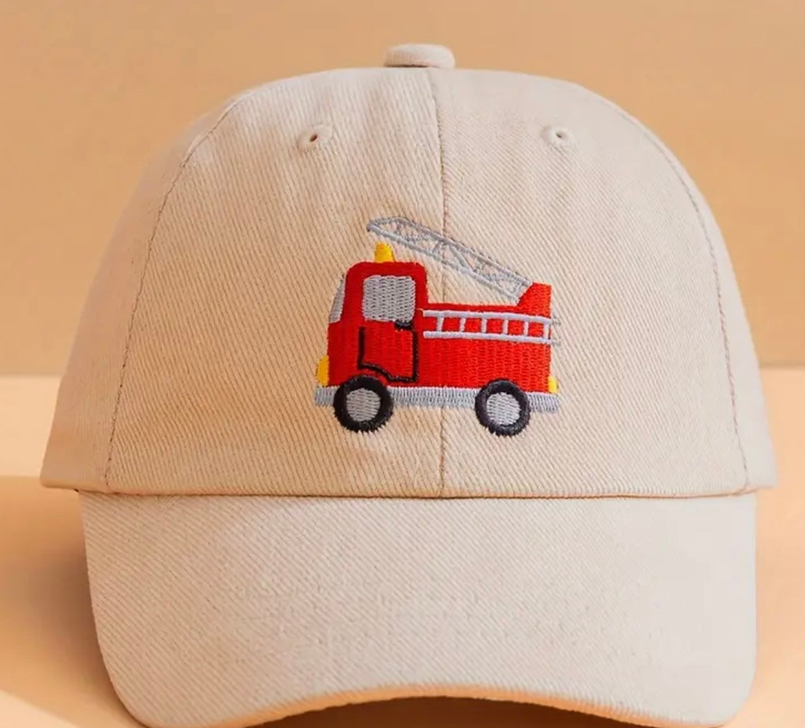 Cream kids' firetruck hat, displaying its soft fabric and sturdy construction, perfect for all-day wear