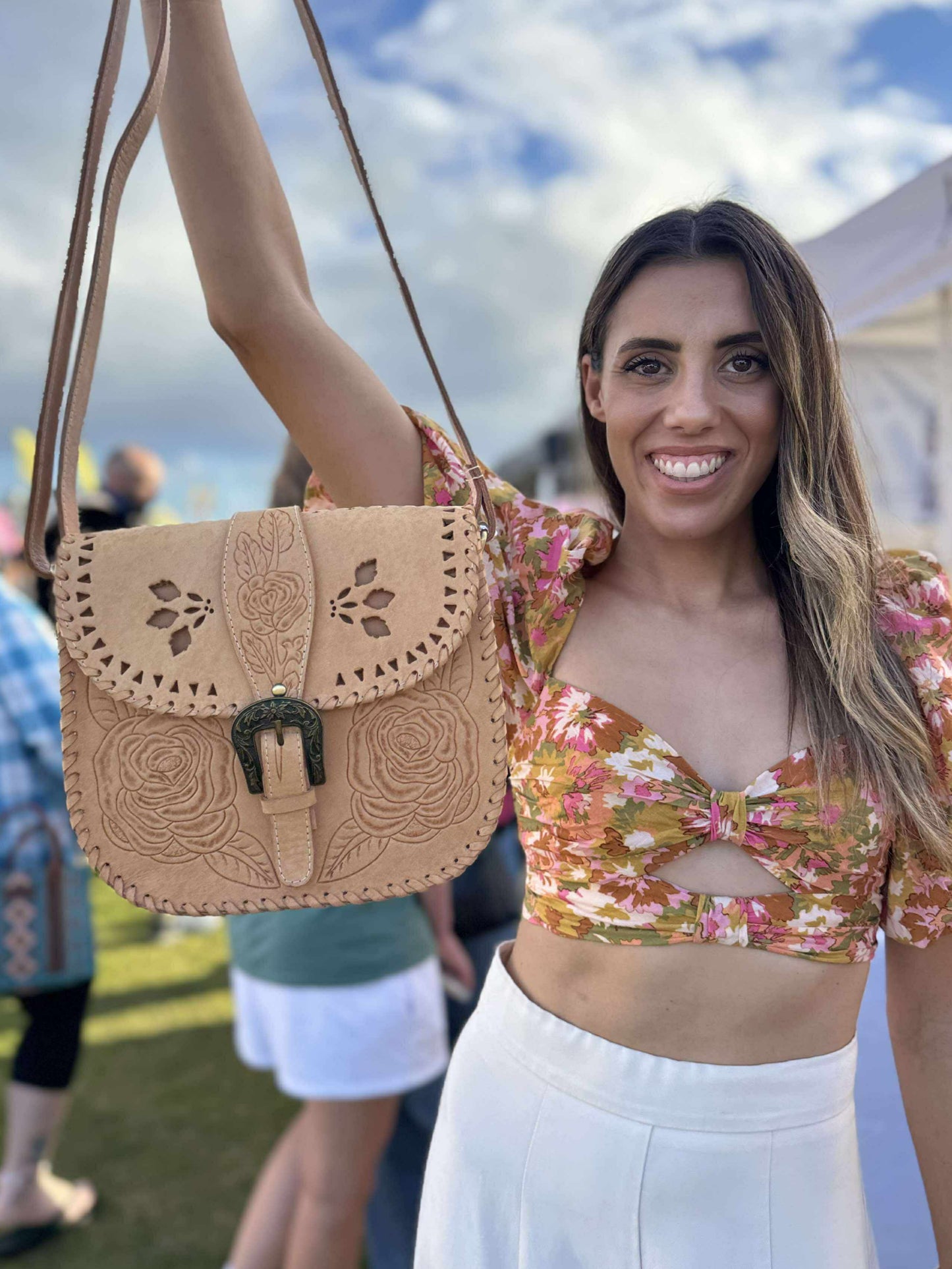 Close-up of the Desert Rose saddle bag – hand-tooled tan leather crossbody with floral design, vintage Western style, and adjustable strap – rustic boho accessory for everyday wear.