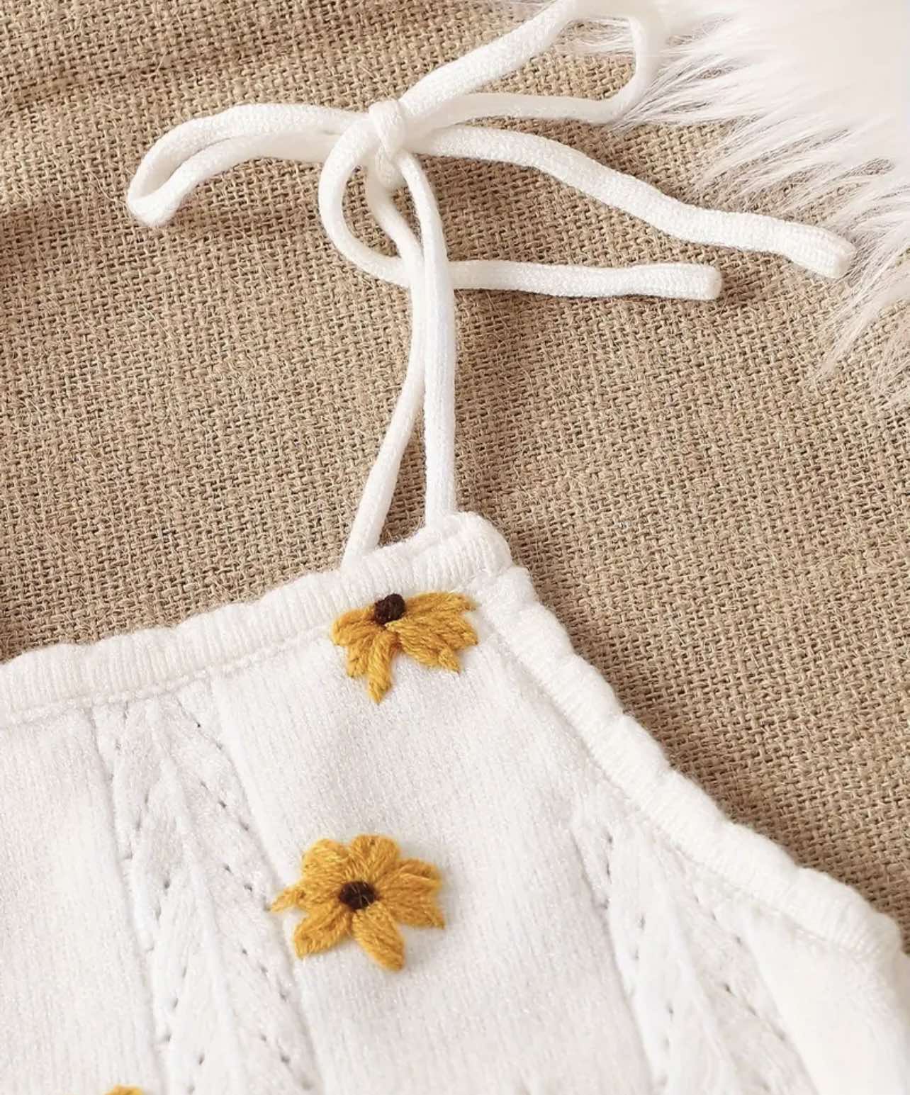 Flat lay of the White Sunflower Knit Two-Piece Set showcasing its soft knit fabric and elegant sunflower embroidery.