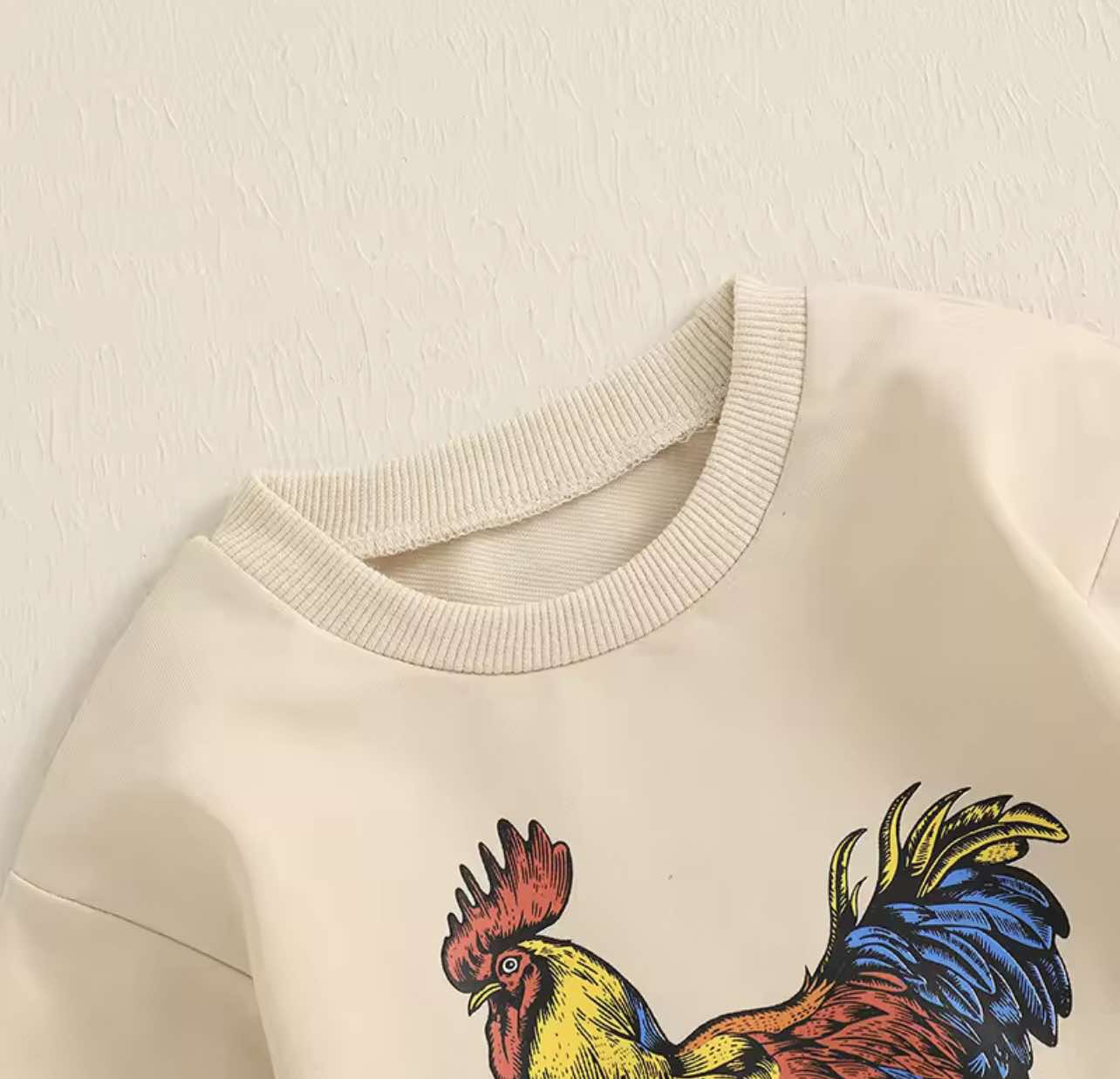 Free Range farmhouse-inspired baby romper – oversized fit with crew neck and snap closures, ideal for cozy rural living.