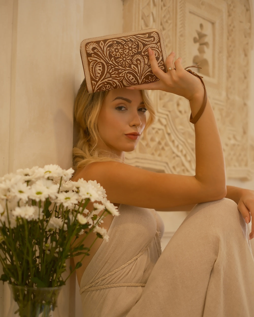 Genuine tan and cream leather wallet with wrist strap, floral tooling, and multiple compartments for cards and cash.