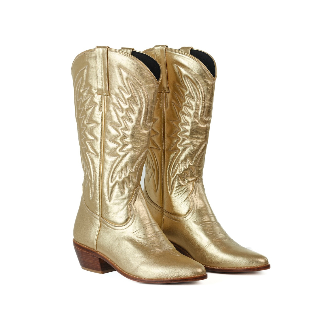 A pair of metallic gold leather cowboy boots with detailed western embroidery on the shafts, shown against a plain white background.