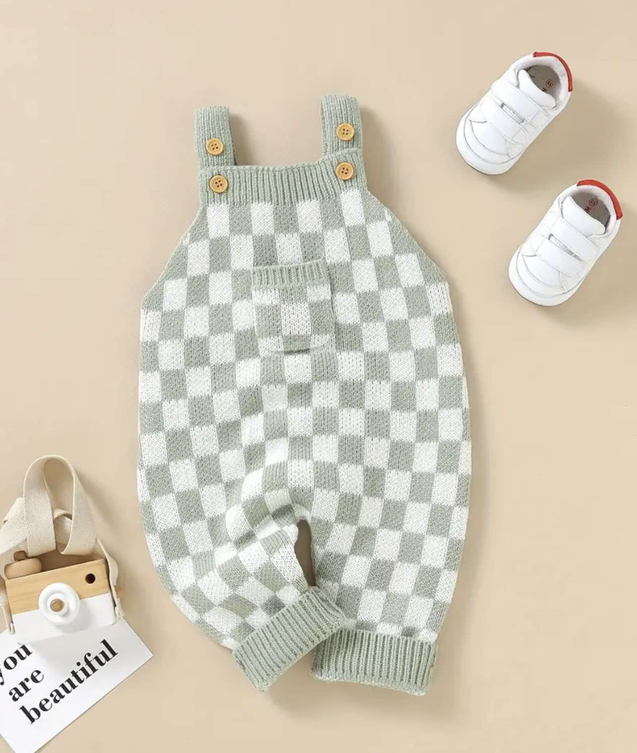 Green sleeveless baby jumpsuit with flap pocket, checkerboard design, and regular fit for everyday wear.