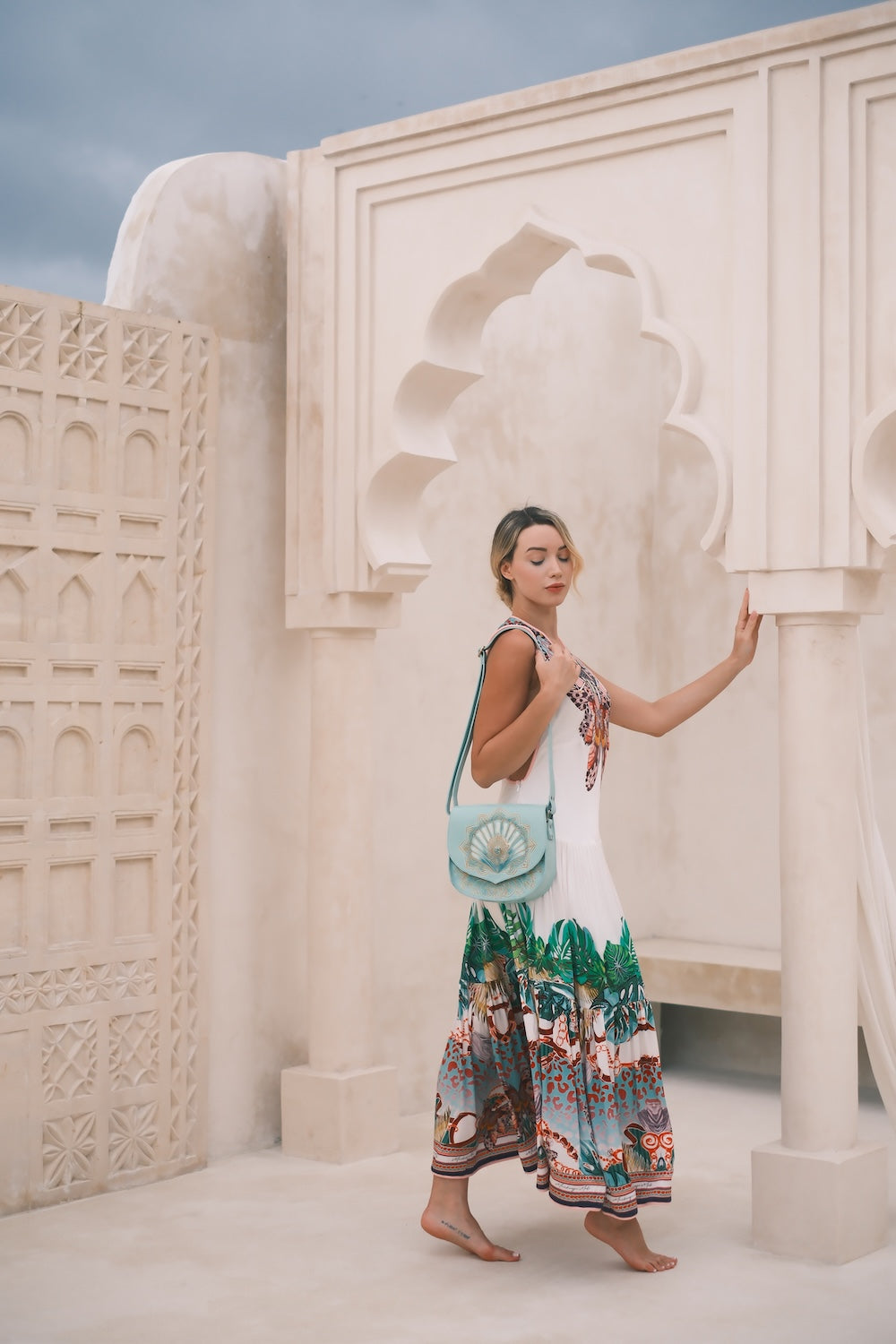Hand‑tooled turquoise leather shell bag inspired by WA’s Coral Coast. Ethical crossbody with brass hardware, shipped Australia, NZ, USA.