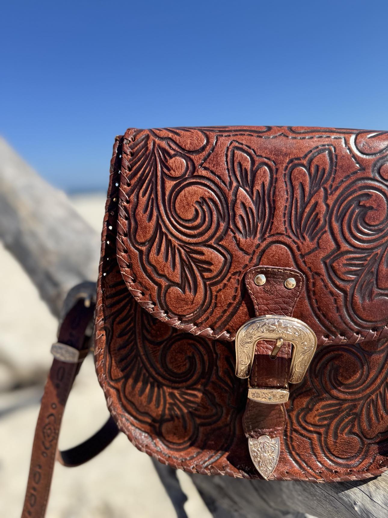 Model wearing Amelia brown leather crossbody bag with boho-inspired outfit