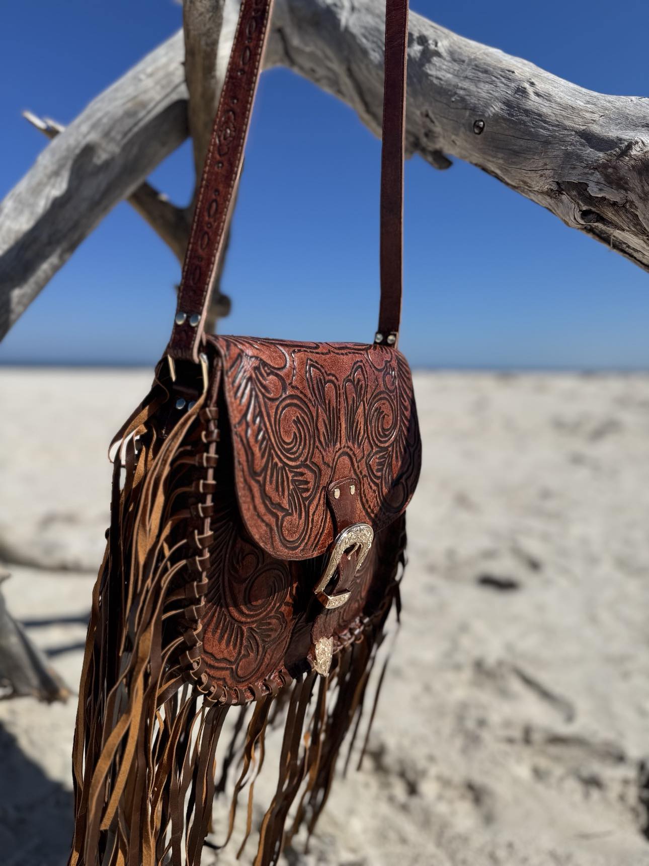 Feyre Fringe Leather Crossbody Bag by House of Hide: Full view of the bag with long, flowing brown leather fringe and adjustable shoulder strap.