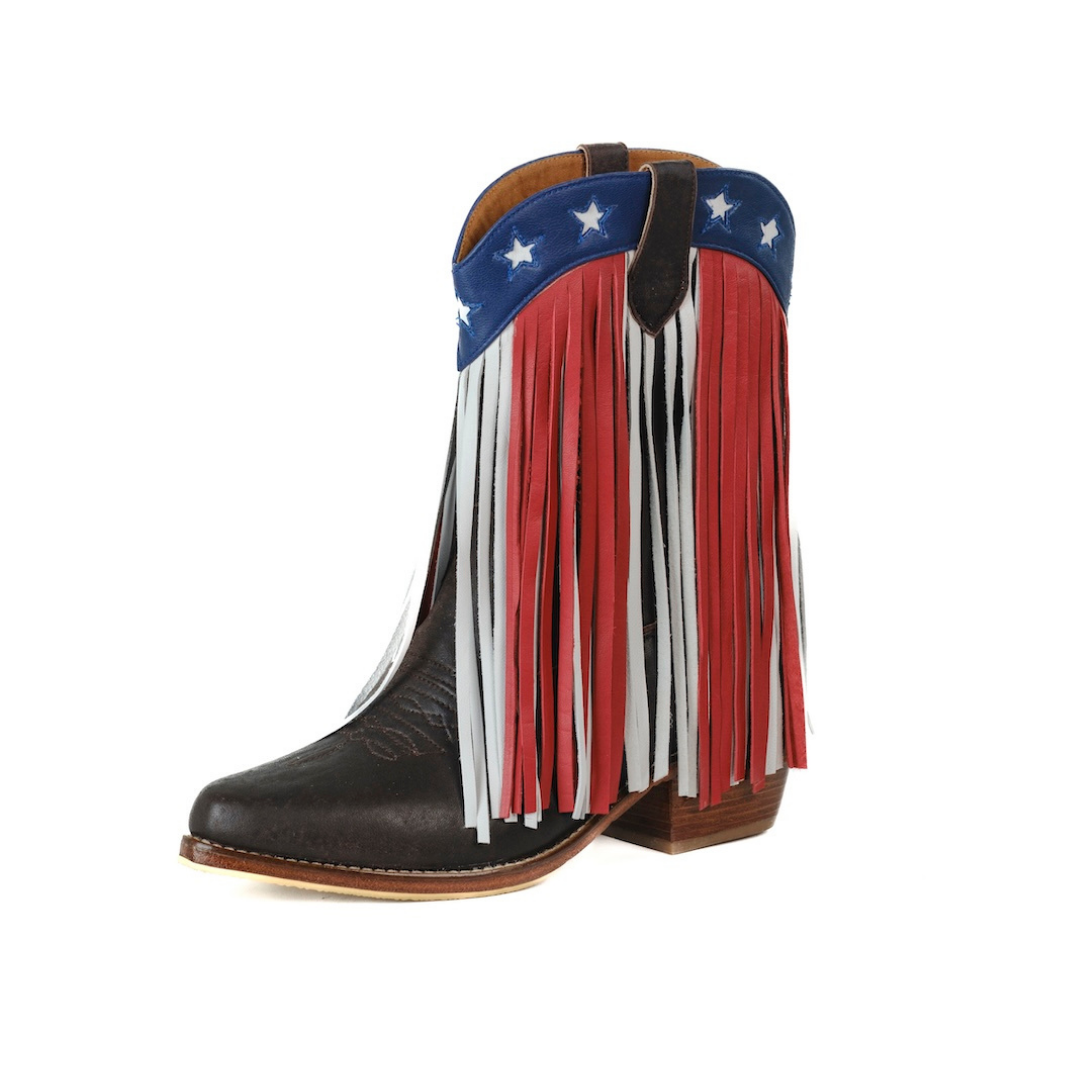 A western-style ankle boot with a black leather toe and shaft fringe, decorated with red, white, and blue fringe panels in an American flag theme, shown on a plain white background.