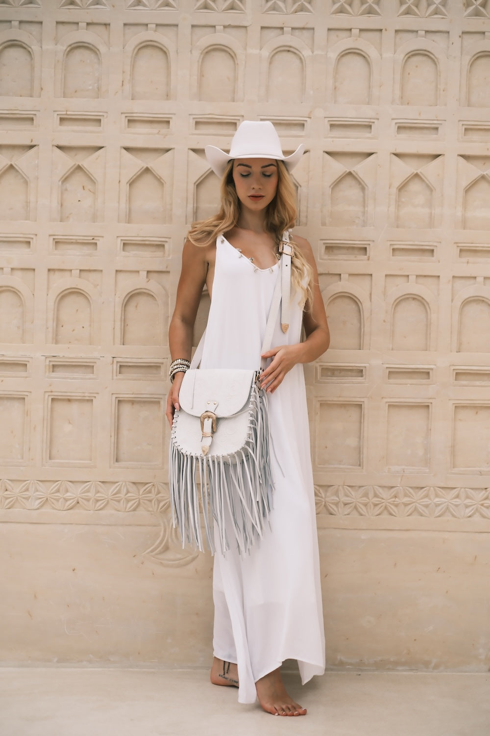 Close-up of the Savannah Western Fringe Bag in Off-White, showcasing hand-tooled floral leather and flowing fringe detail.