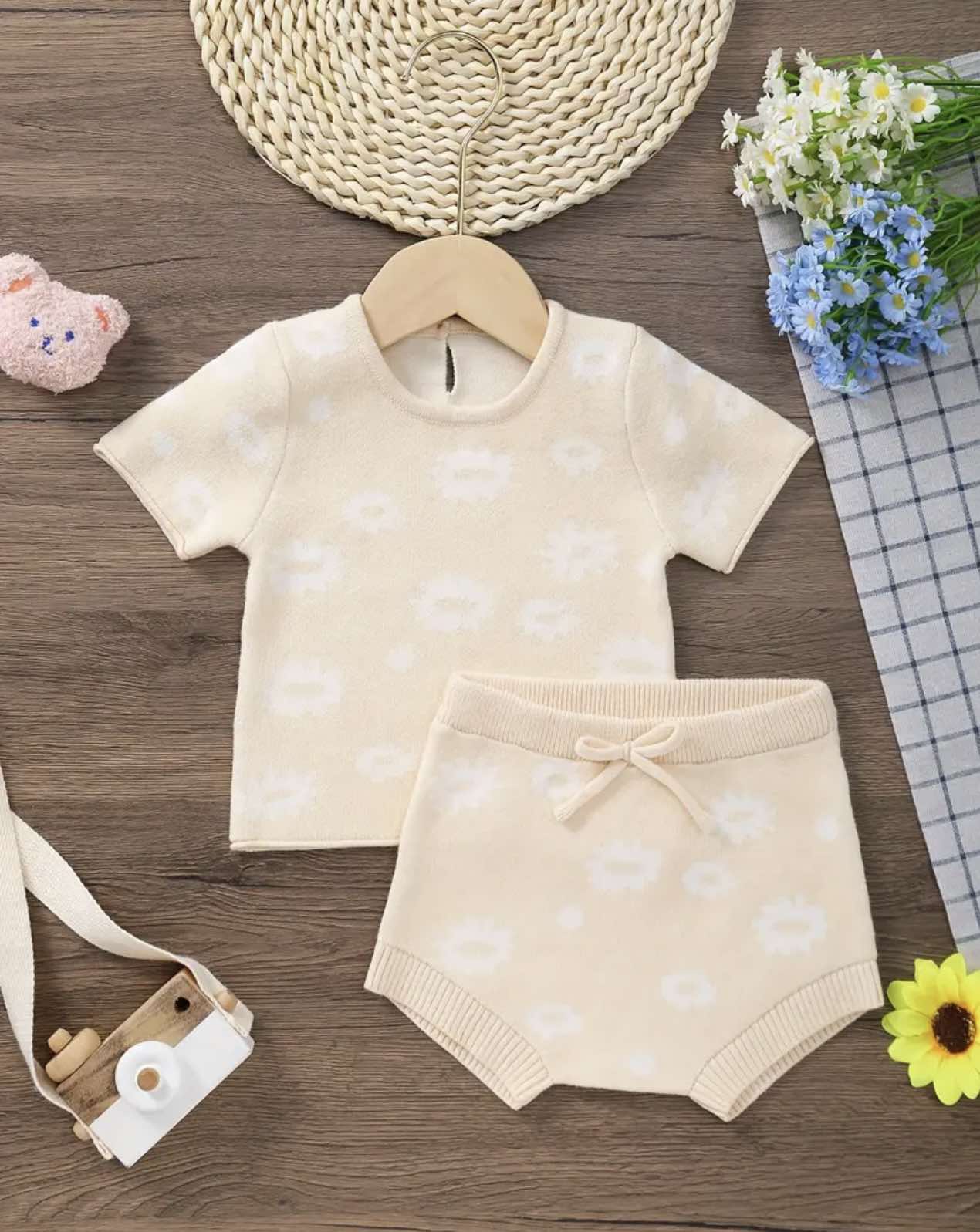 Serafina Baby Set in soft knitted fabric featuring a short-sleeve floral top and matching shorts, perfect for summer.