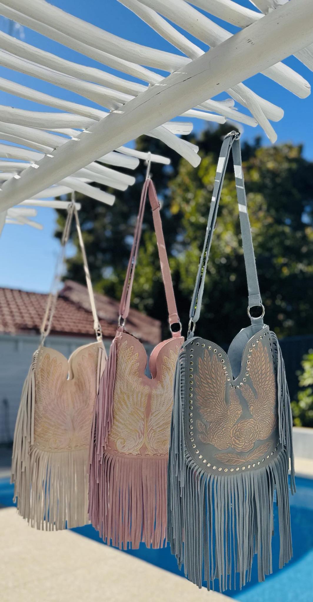 Small-batch boho bag in pastel pink with western fringe and spiritual design