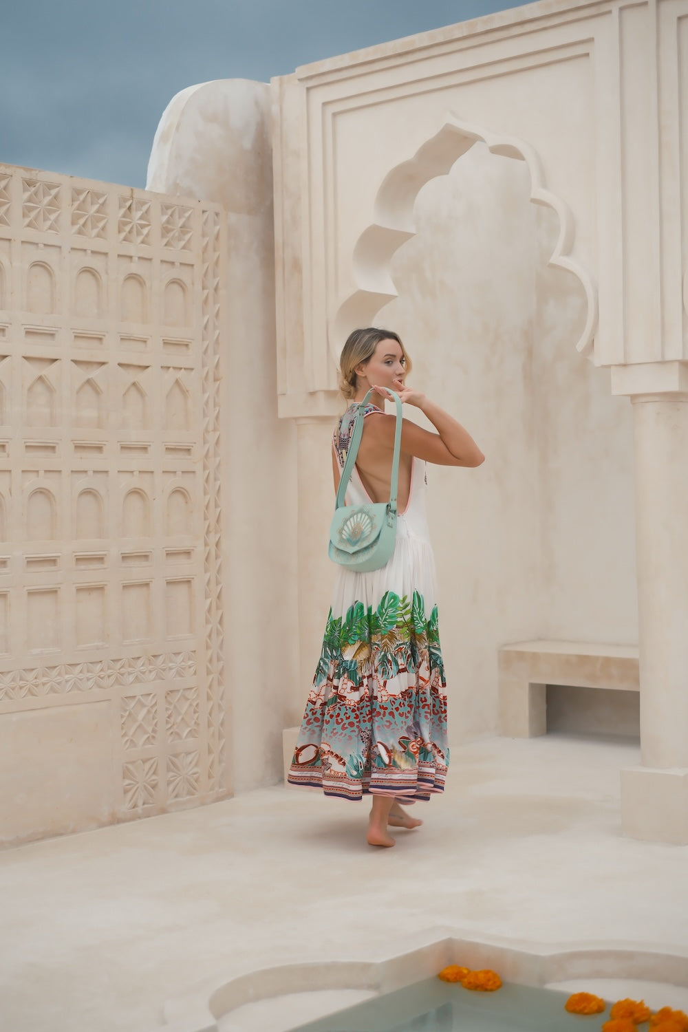 Turquoise leather crossbody with hand‑tooled shell design. Ethically made in WA, inspired by Monkey Mia. Ships Australia, NZ, USA & worldwide.