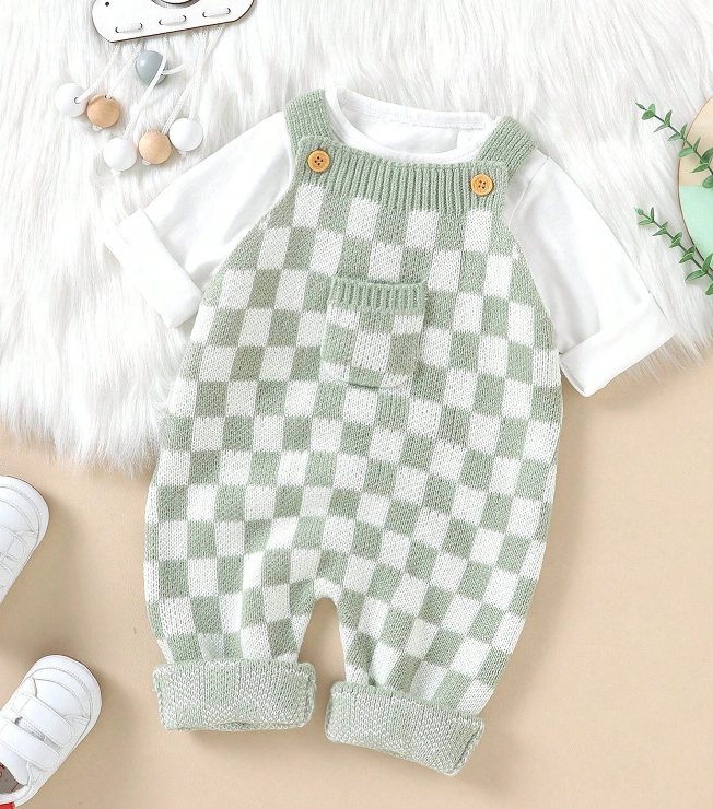 Unisex baby jumpsuit with green checker pattern and wooden button strap details, designed for comfort.