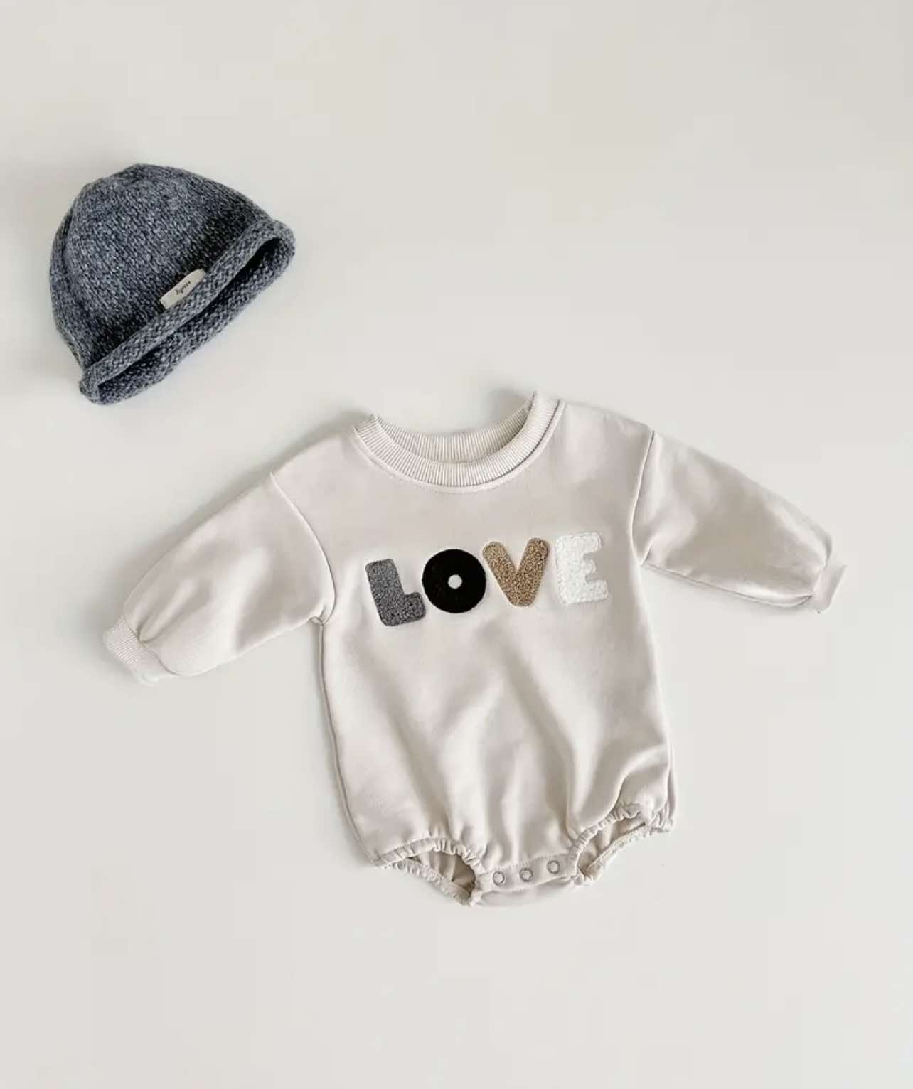 Unisex baby romper in beige, designed for comfort and warmth during Australia's cooler seasons.