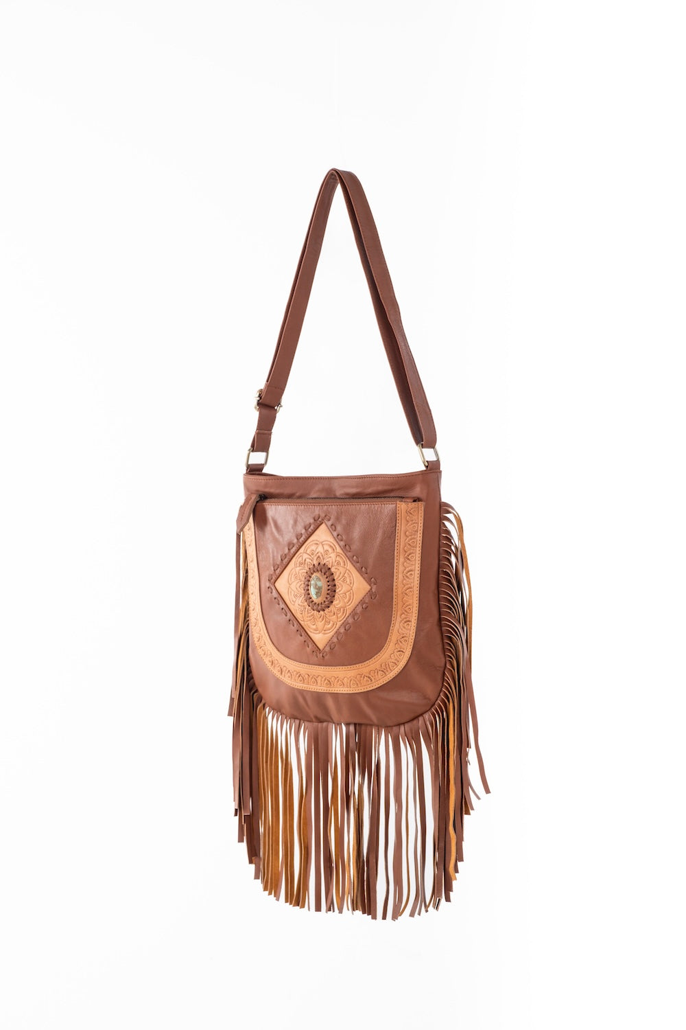 Western-inspired leather and suede fringe bag with intricate tooling, shell detail, and free-spirited bohemian style.