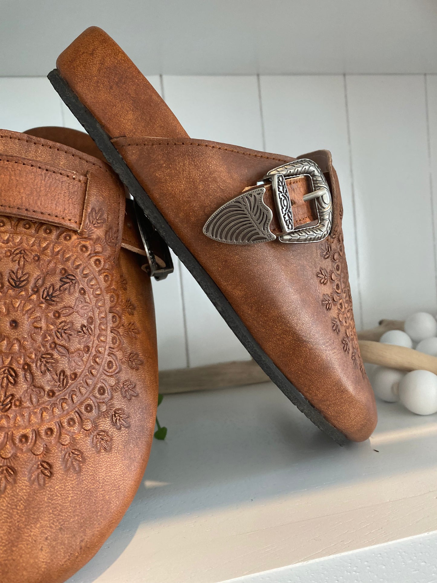 Western Buckle Boho Clogs worn with jeans – Clogs styled with shredded mom jeans, highlighting their versatility for casual day-to-night looks.