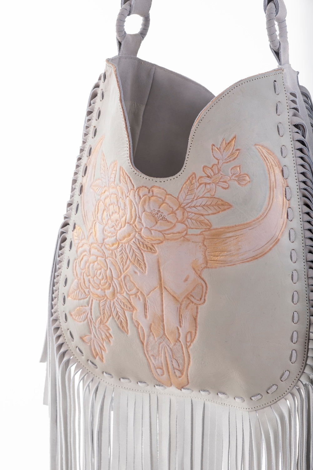 White leather bullhead floral handbag with fringe, adjustable strap, and artisan handwoven edge by House of Hide."