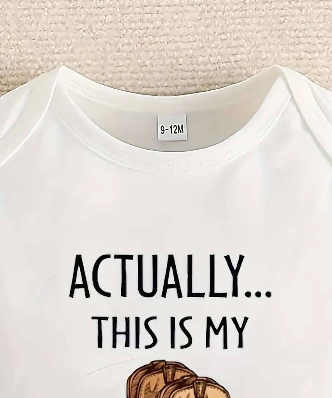 White baby onesie featuring "Actually This Is My First Rodeo" text in bold Western-style print.
