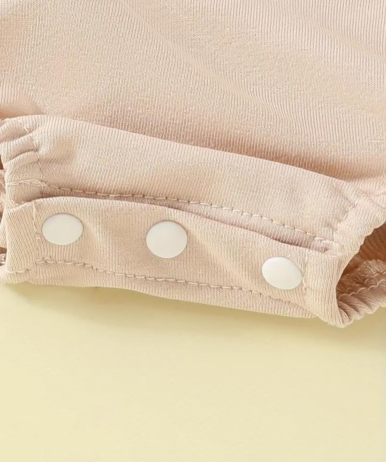 Close-up of the soft cotton fabric and embroidered bull design on the Behind the Bull romper, showcasing high-quality craftsmanship and Western charm.