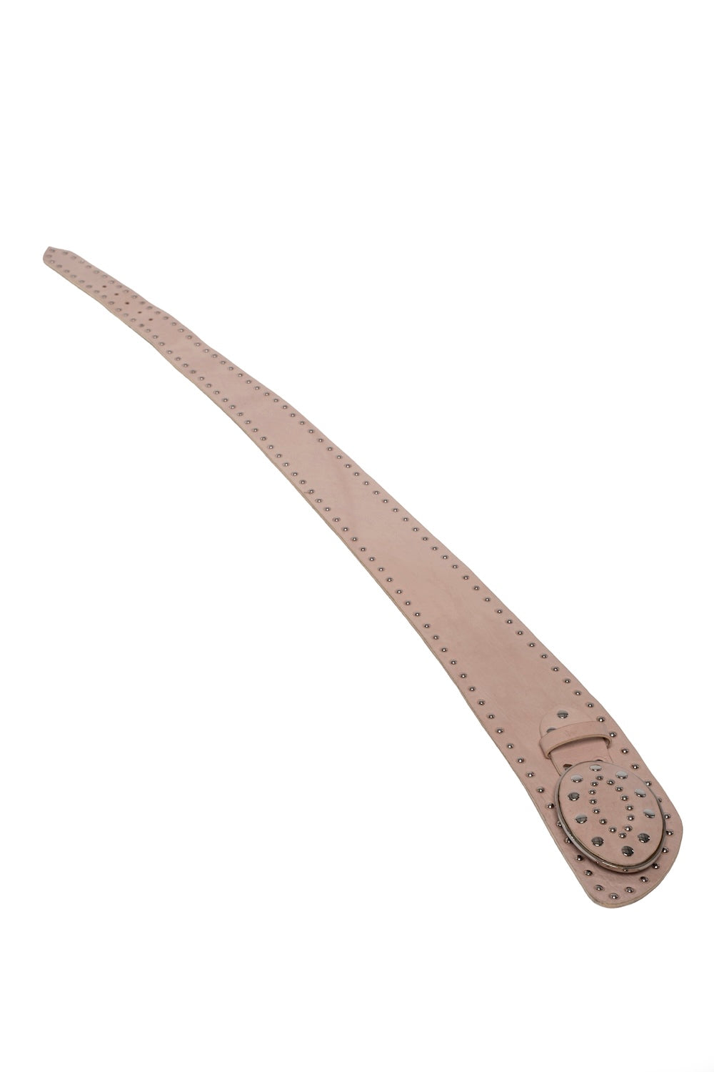 Close-up of cream studded belt styled over a flowy white dress