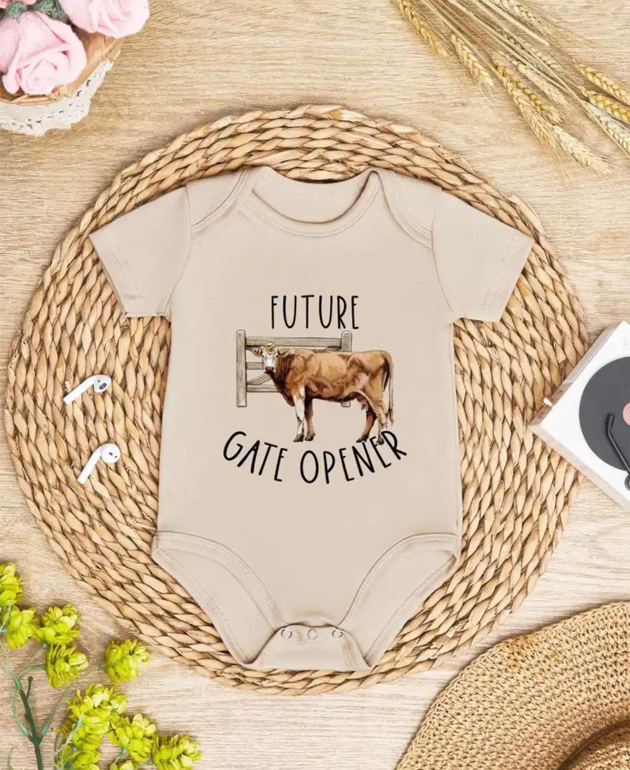 White baby onesie with "Future Gate Opener" text, perfect for farm and ranch families.