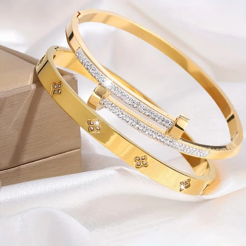 Gold stackable bangle bracelets detailed, clover flower charm jewelry, pave crystal everyday fashion accessory.