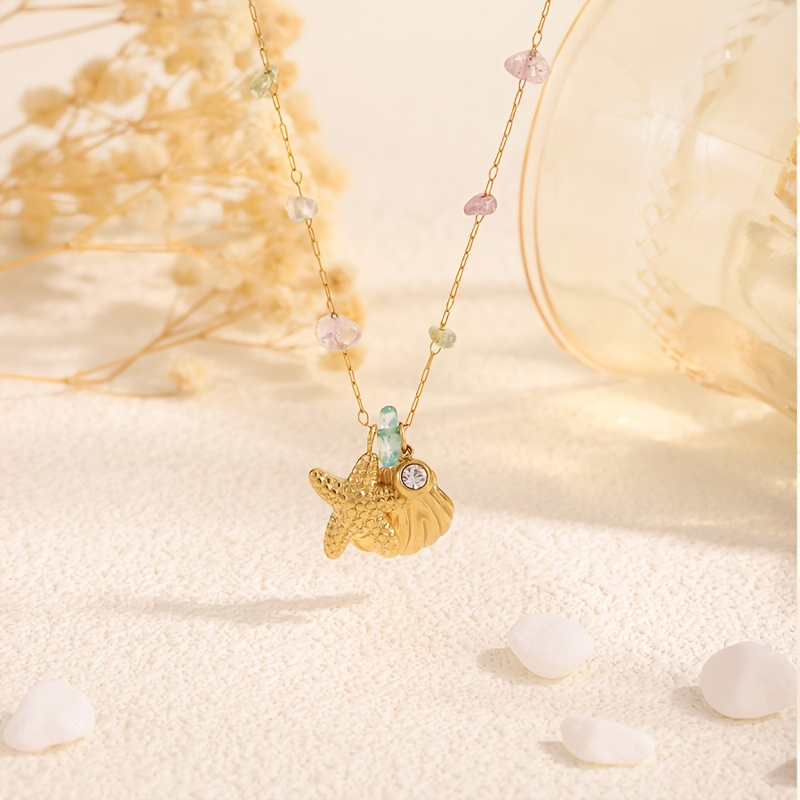 Golden starfish shell necklace with beads on a sandy background