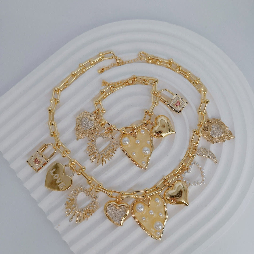 Gold chain with heart-shaped charms on a white background