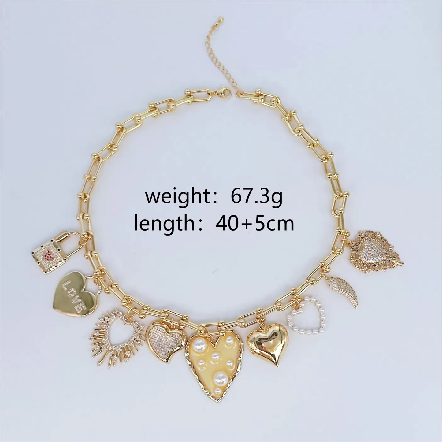 Gold chain with charms on a light blue background