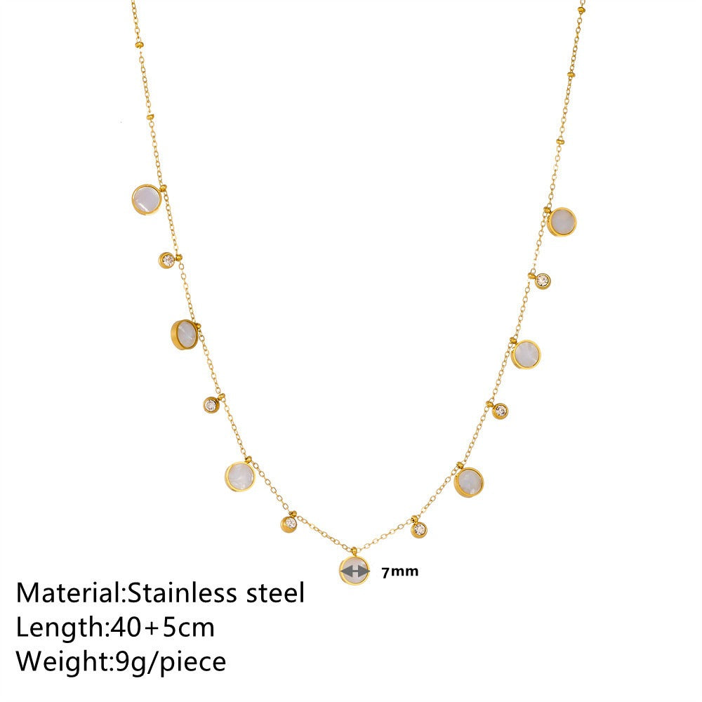 Gold necklace with gemstones on a white background