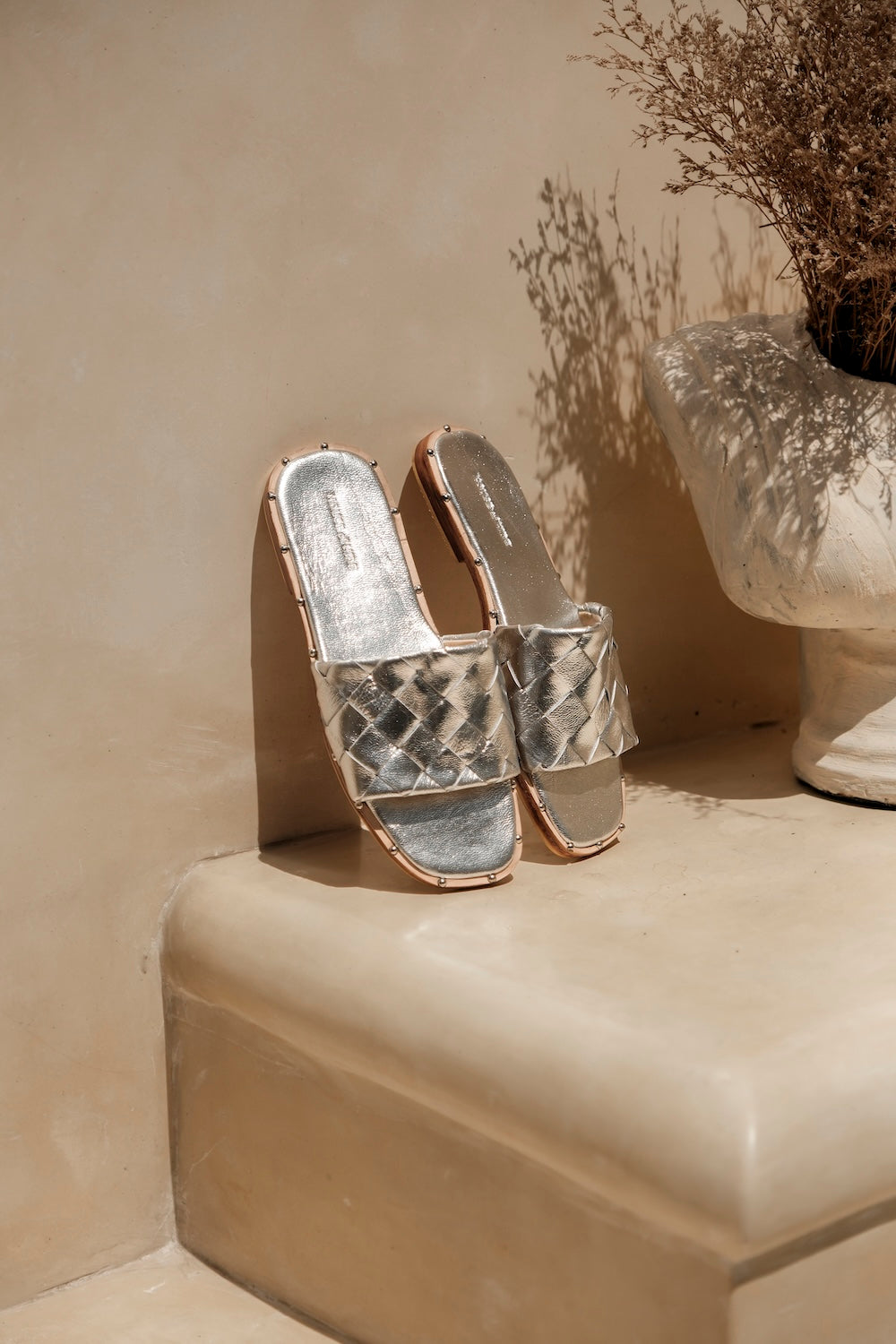 Bottega-inspired woven leather flat mule in silver, Australian women’s leather slide sandal styled with summer skirts