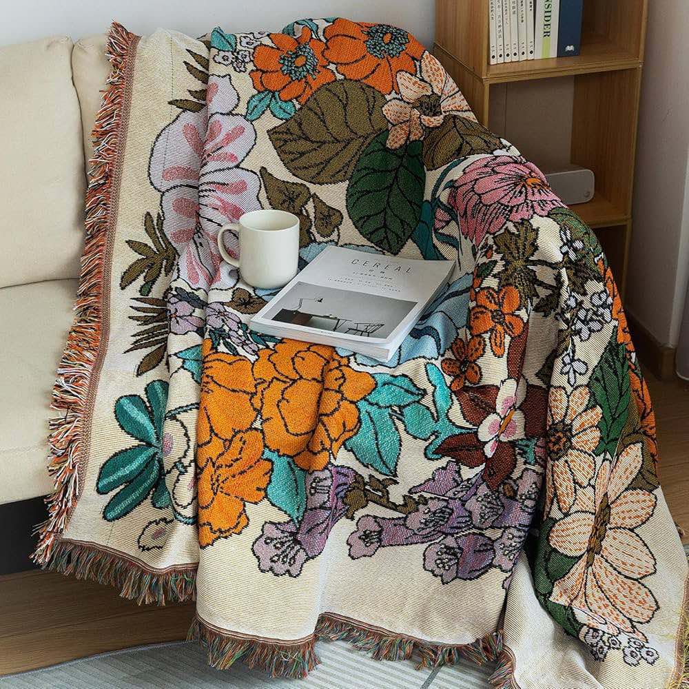 Botanical Throw / Blanket / Beach Rug Australia draped on a couch, showcasing intricate flower and leaf patterns