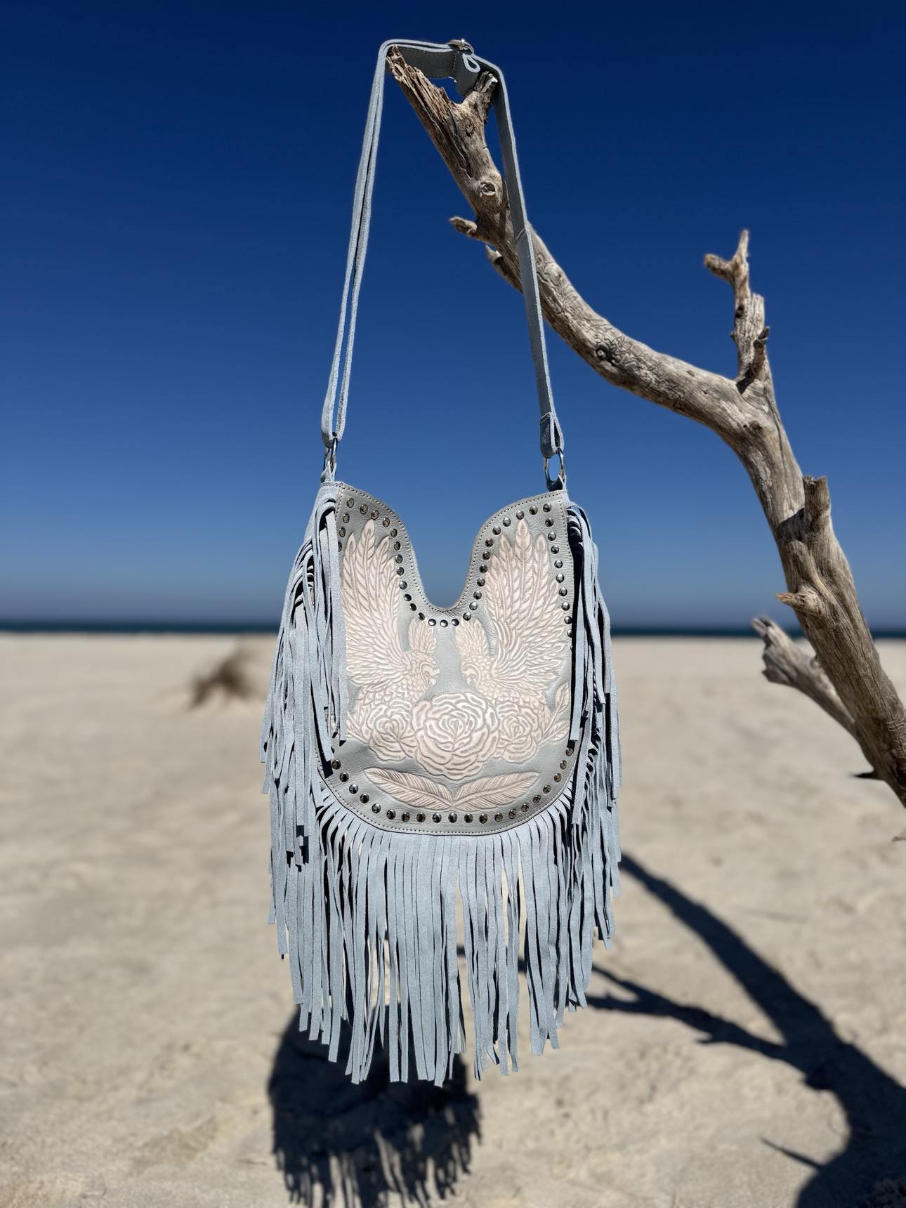 Australian-designed boho leather bag with fringe details, tassels, and adjustable strap for 2025 summer style