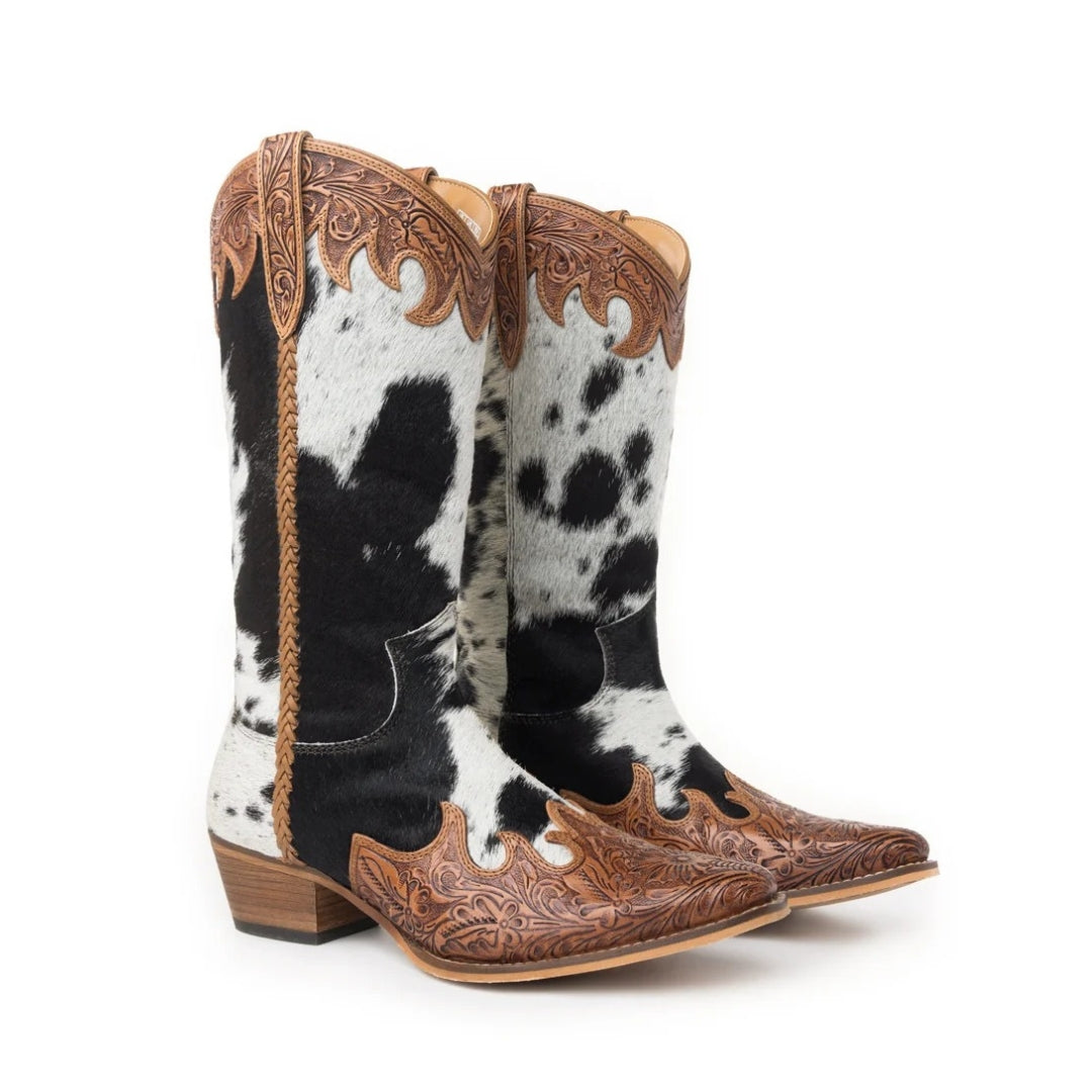 Pair of Adelaide cowboy boots with black and white cowhide, honey-toned floral tooling and braided side detailing.