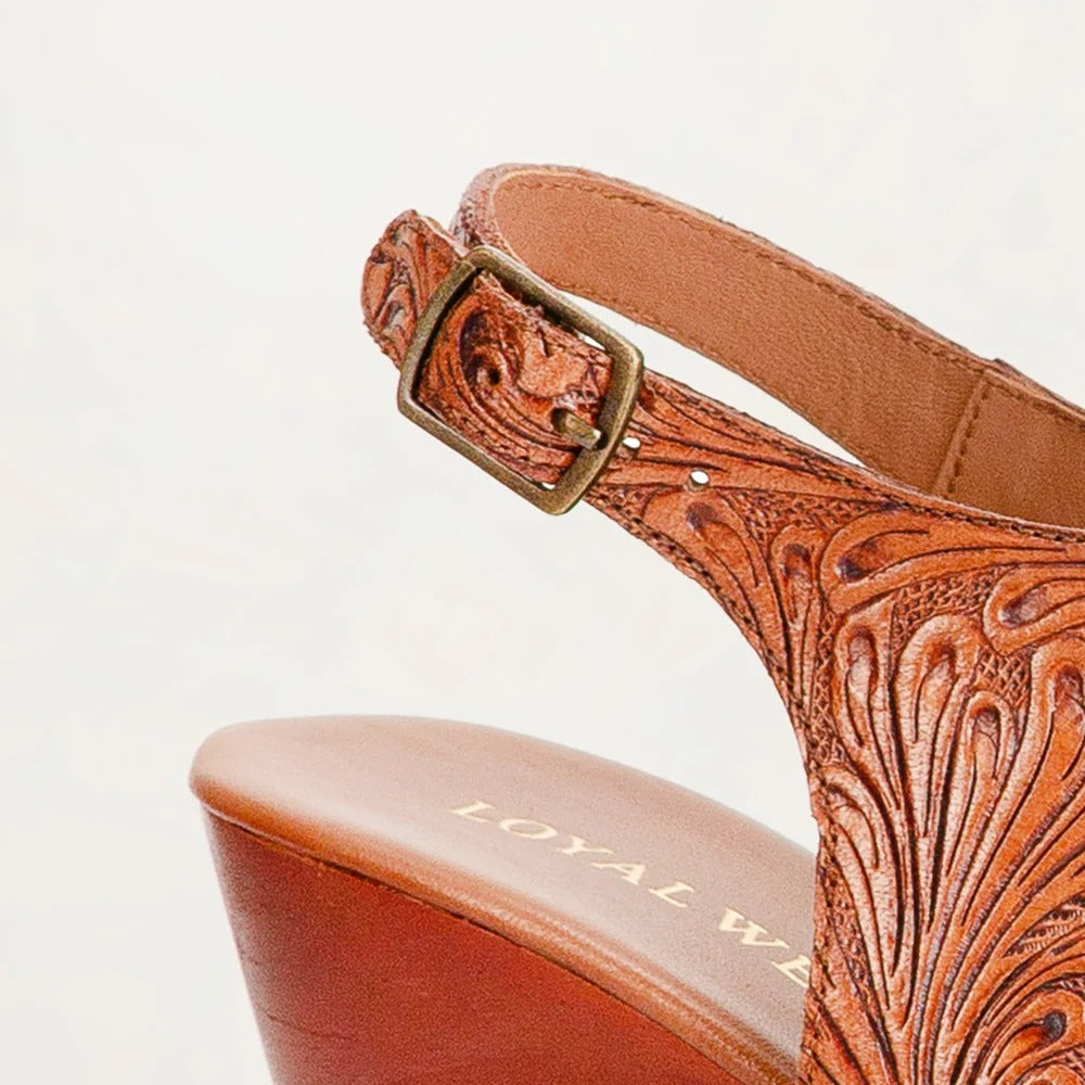 Amelia Sandals from House of Hide in brown leather with intricate design and  branding being displayed in close-up on white background