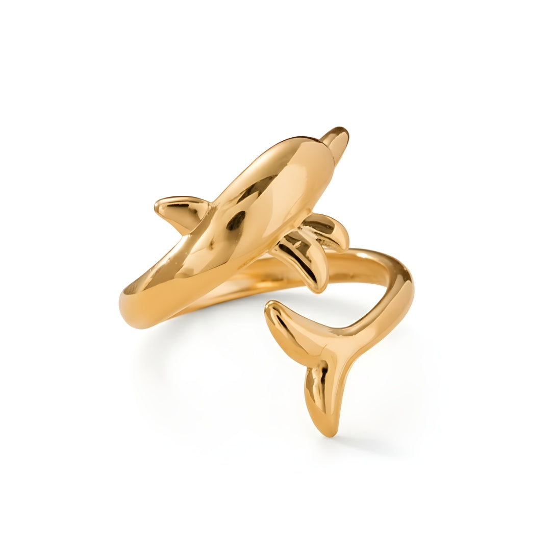 Gold-plated AquaSpirit Dolphin Ring displayed on a seashell background for a beachy aesthetic.