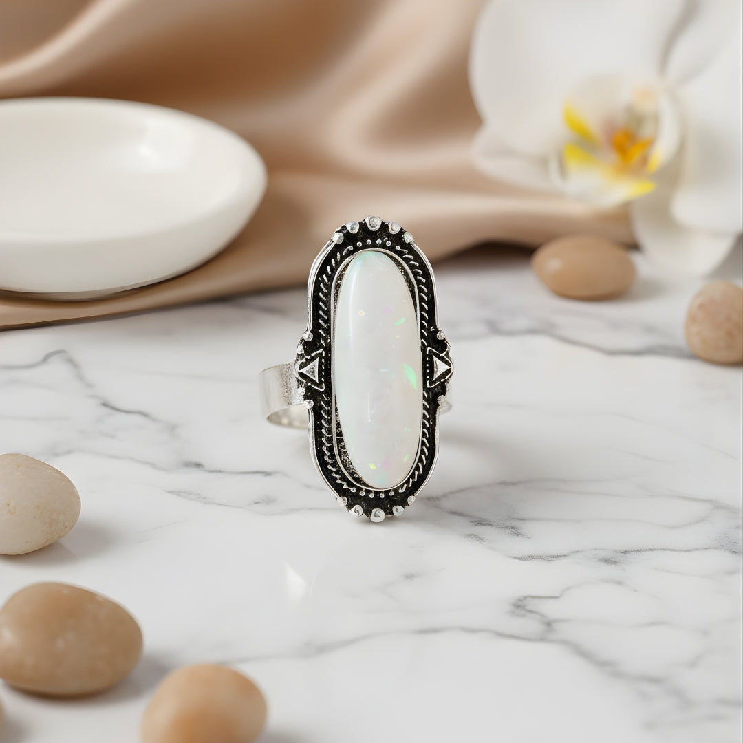 Aurora Reef Opal Ring Perth Australia House of Hide silver ring with oval gemstone on marble surface