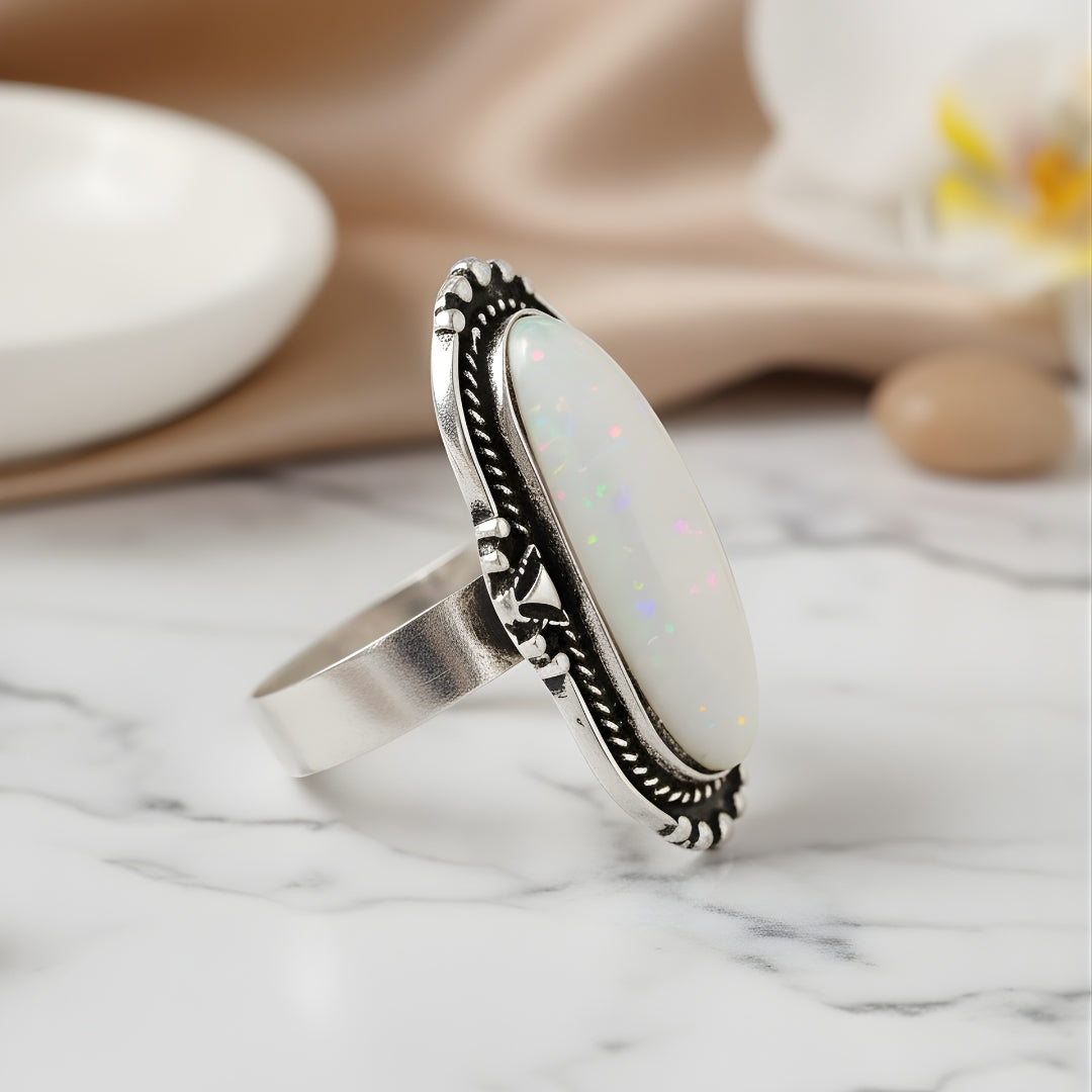 Elegant Aurora Reef Opal Ring displayed on marble with neutral background luxury jewellery