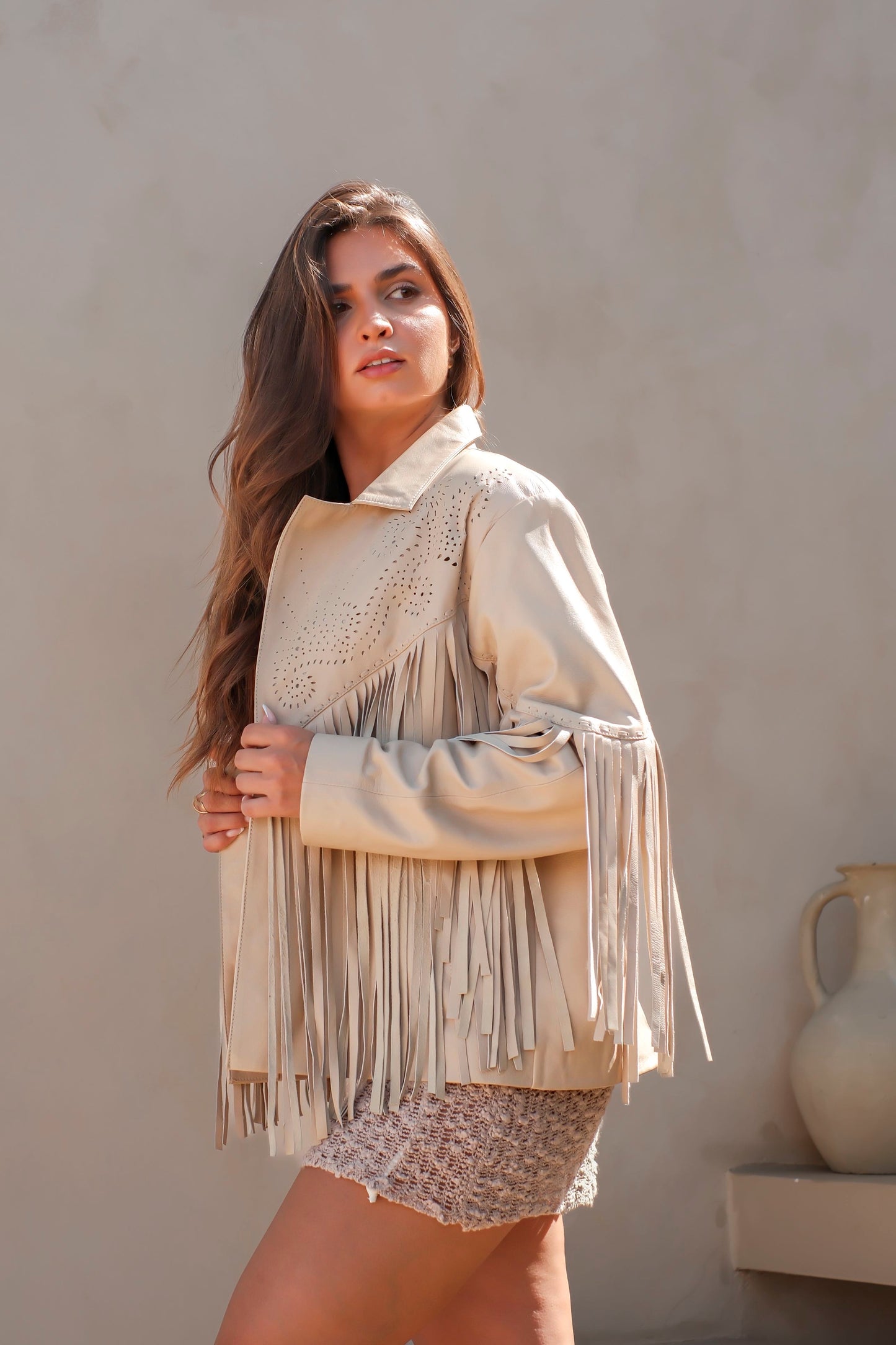 Shop women’s fringe leather jackets Australia. Cream western-style jacket with laser cut detail and soft goat leather. Handmade, timeless, and bold.