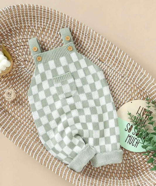 Baby girl green and white checker pattern knit jumpsuit with flap pocket and strap shoulders.