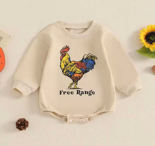 Baby in Free Range Rooster Romper on the farm – long-sleeve country baby outfit with rooster print, soft cotton, newborn to 24 months.