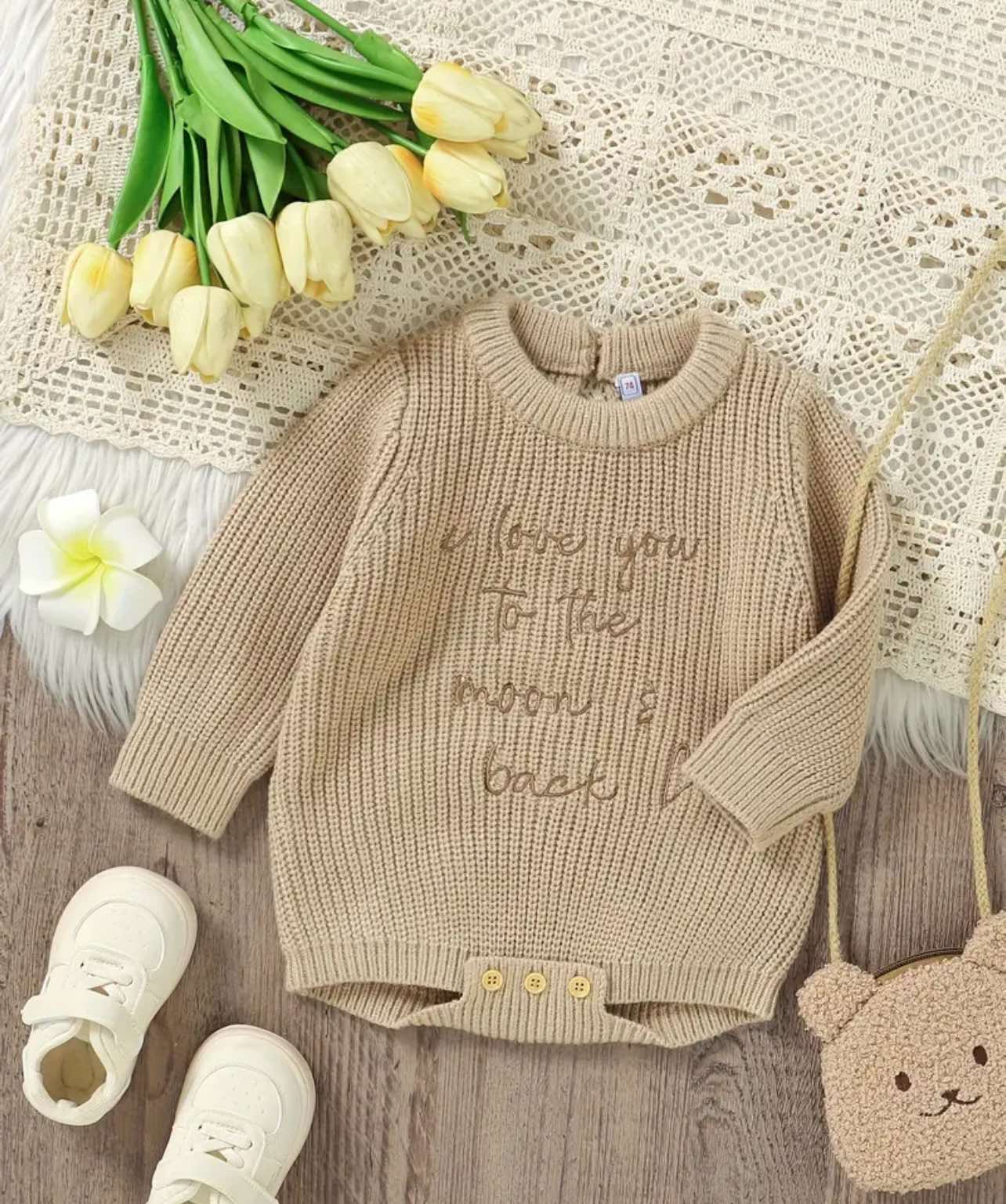 Baby romper with vintage-inspired knit texture, elegant beige tone, and wooden button details—an aesthetic and comfortable choice for little ones in Australia.