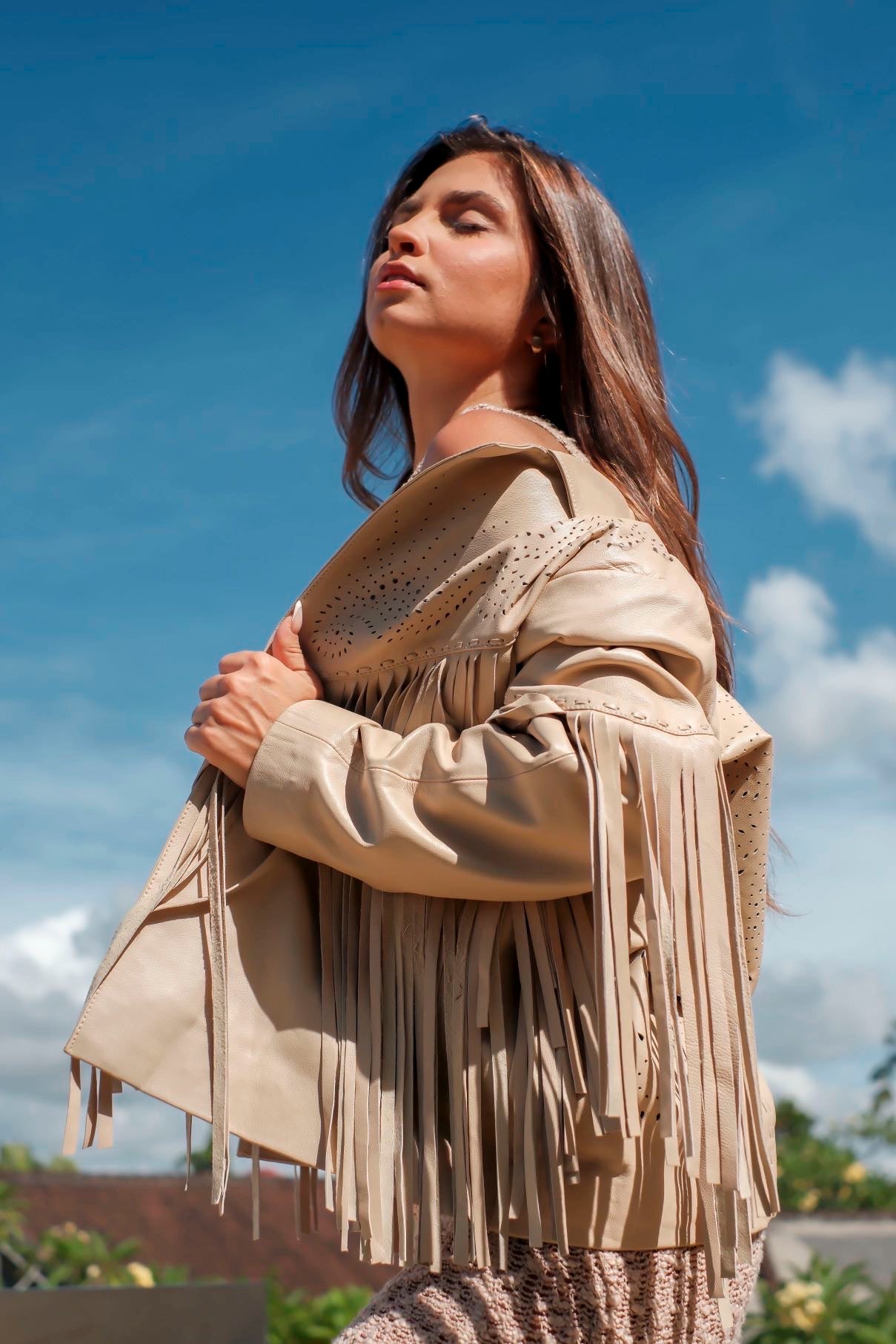 Back view of cream goat leather jacket featuring shoulder cut-outs and statement fringe