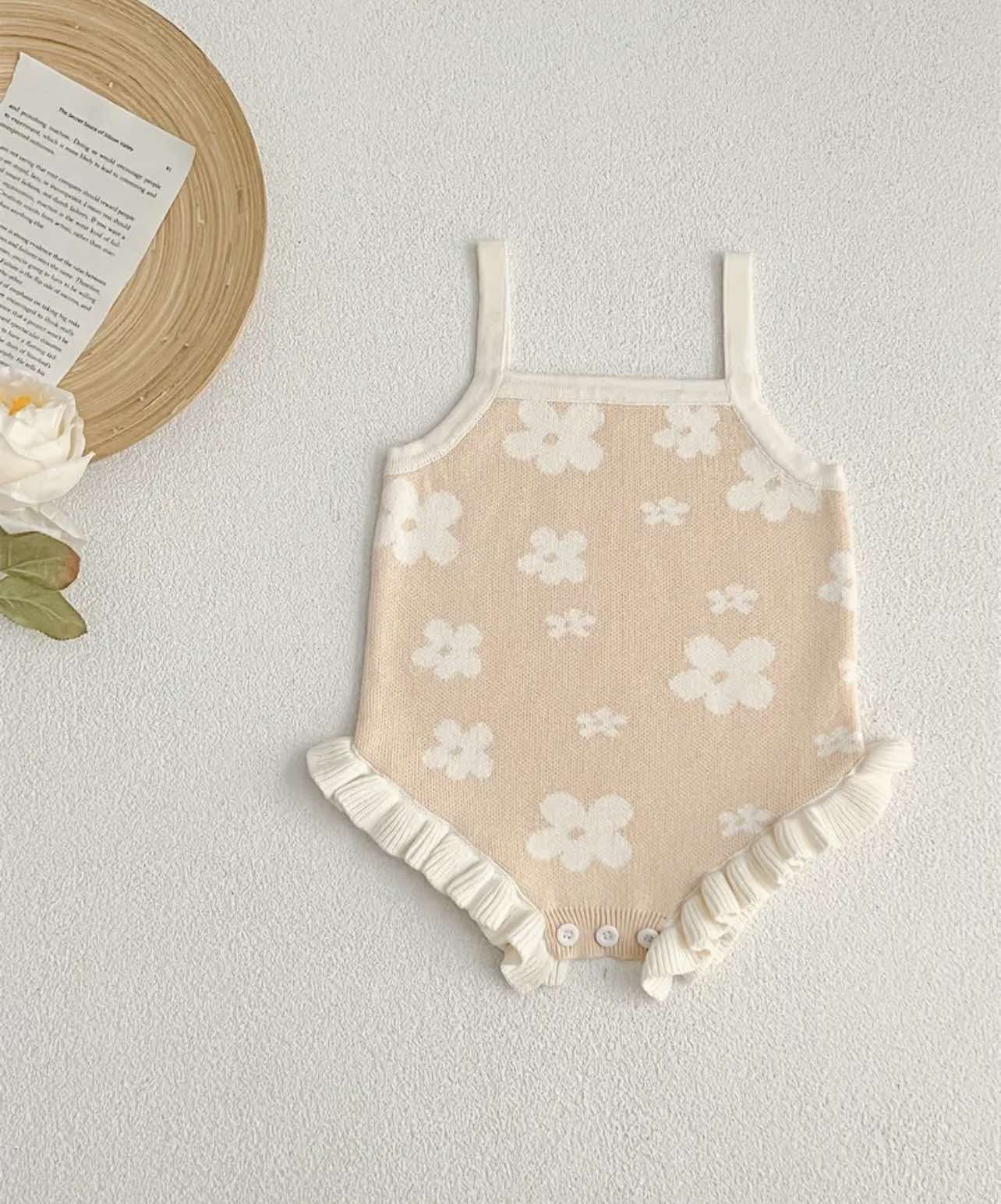 Beige floral knitted romper for summer, soft cotton fabric with detailed flower pattern, ideal for ages 3-6 months.